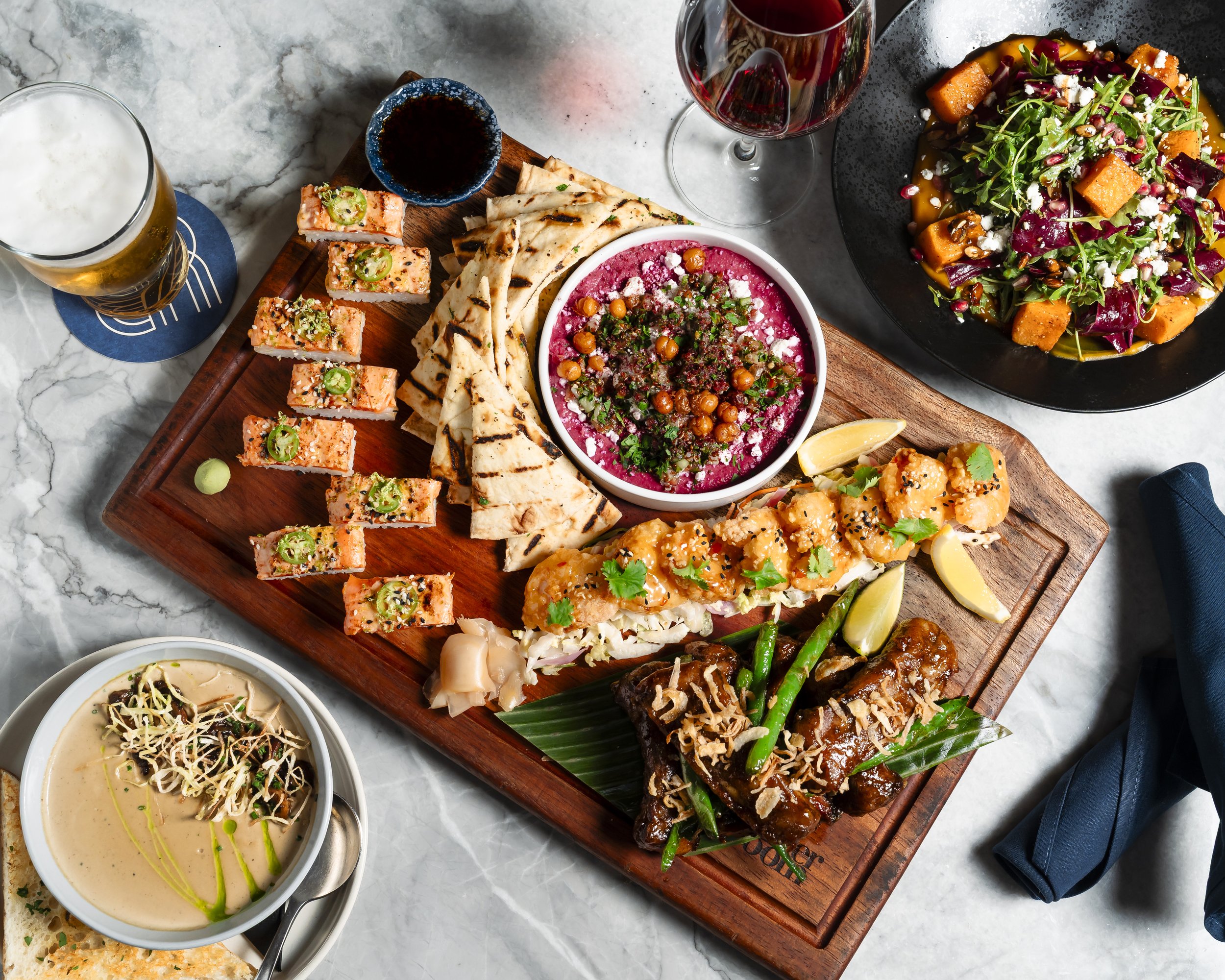 A platter of sushi, flatbread, hummus and other shared dishes at Banter Room.