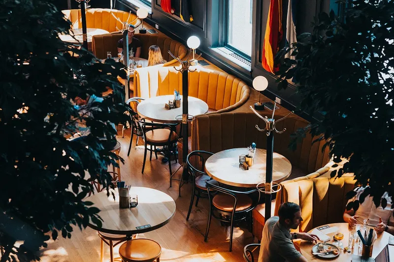 Curved booths and round tables inside Brass Fish Tavern.