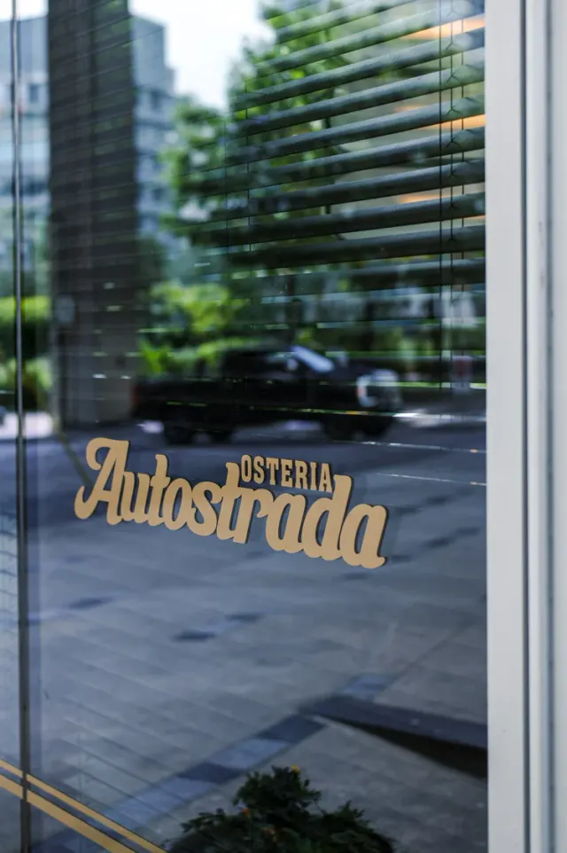 Gold Autostrada Osteria lettering on the Vancouver House restaurant's street-facing window.