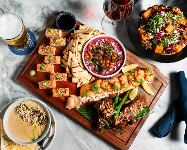 A platter of sushi, flatbread, hummus and other shared dishes at Banter Room.