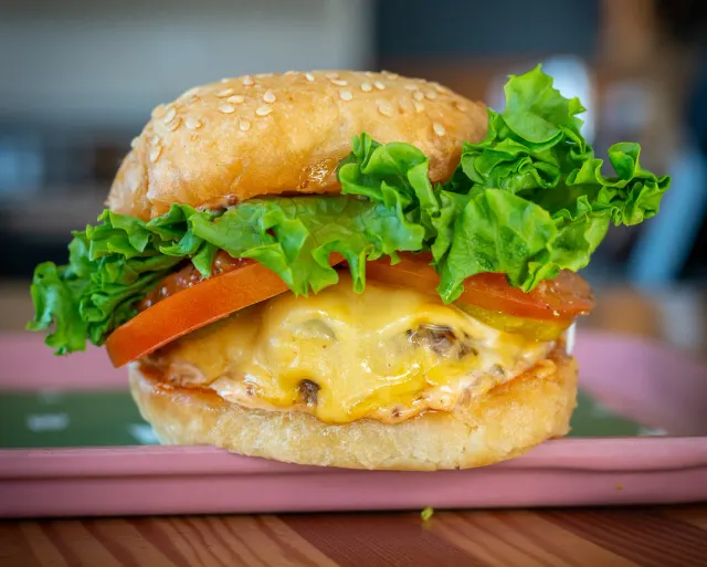 Cheeseburger with lettuce and tomato at Bells and Whistles.