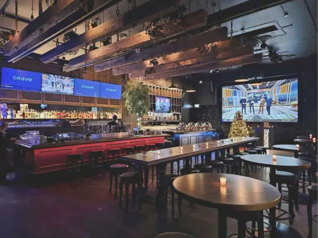 The bar, tables and large screens inside Bimini's in Kitsilano.