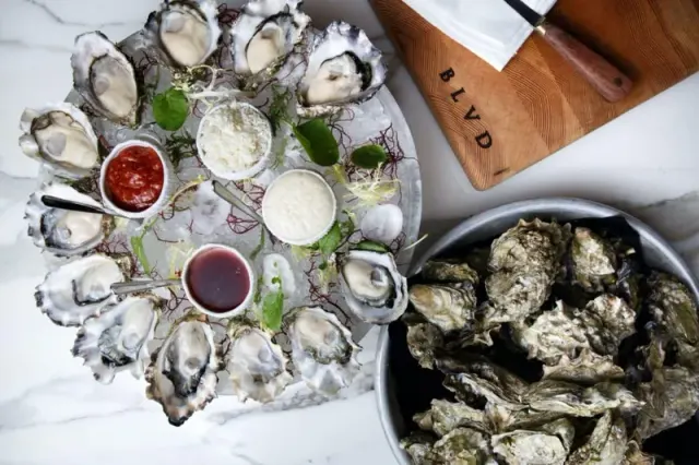 Fresh oysters arranged on ice with sauces and citrus at Boulevard.