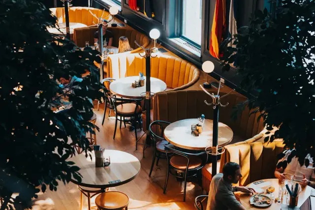 Curved booths and round tables inside Brass Fish Tavern.