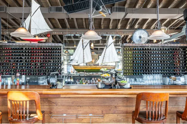 The bar at Cardero’s with bottles and a model sailing ship.