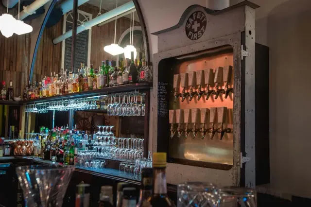 Bottles and taps behind the bar at Clough Club.