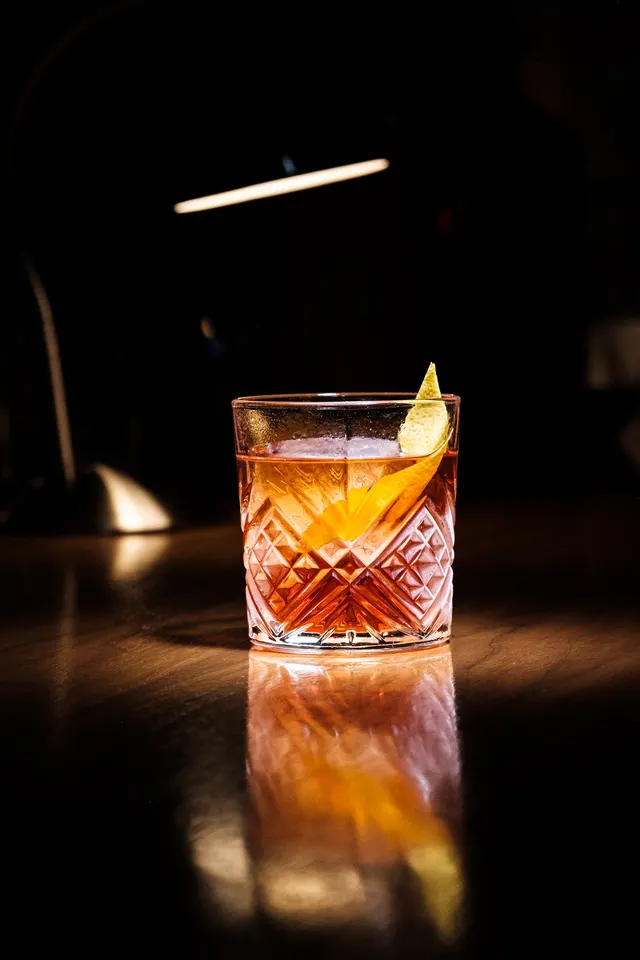 Amber cocktail with citrus peel on the bar at Bar Corso.