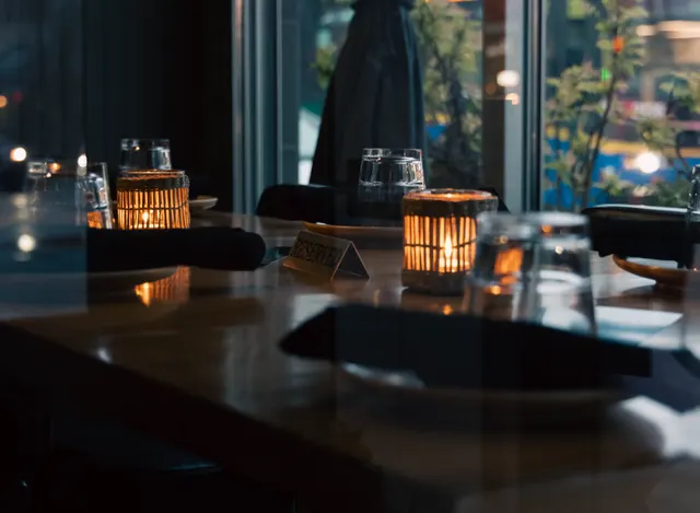 Candlelit tables beside the windows at Davie Social.