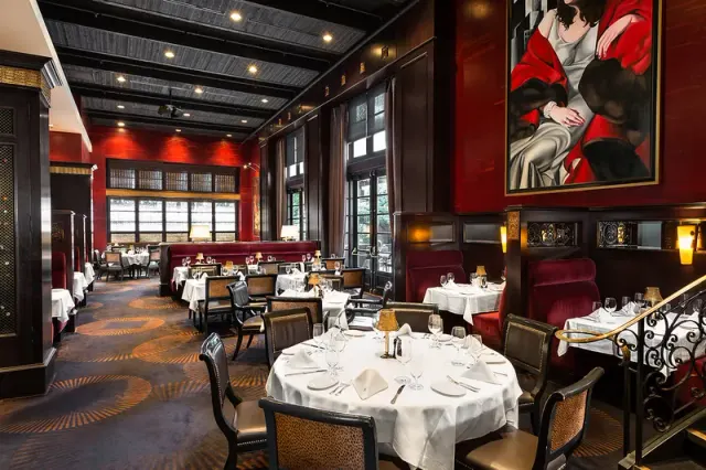 Set tables and upholstered seating in the dining room at Gotham.