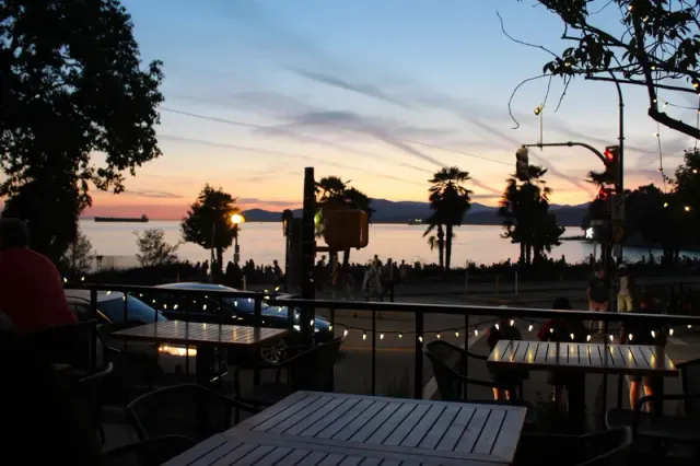 Patio tables looking toward the water at sunset at Hook Seabar.