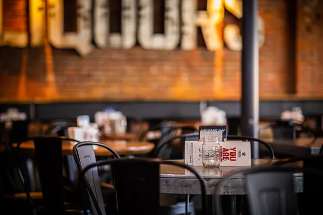 Tables and brick walls inside LOCAL Public Eatery Gastown.