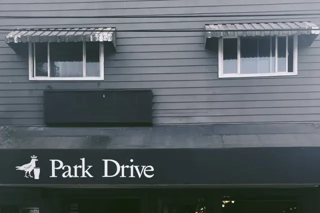 Park Drive pub frontage and awning beneath upper-storey windows.