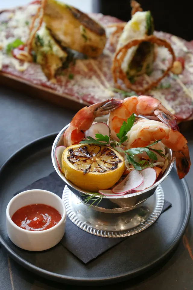 Shrimp, charred lemon and radish served in a silver bowl, from Riley's Fish and Steak Vancouver.