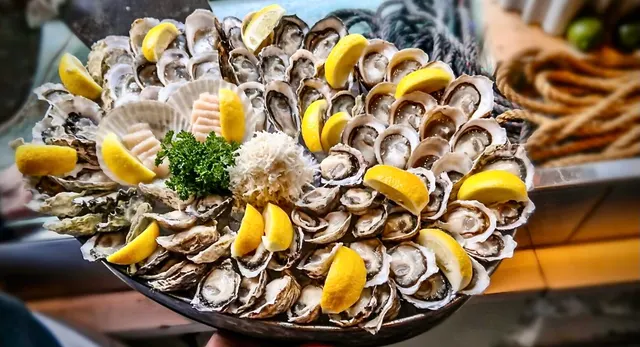 An oyster and shellfish platter with lemon wedges from Rodney's Oyster House Yaletown.