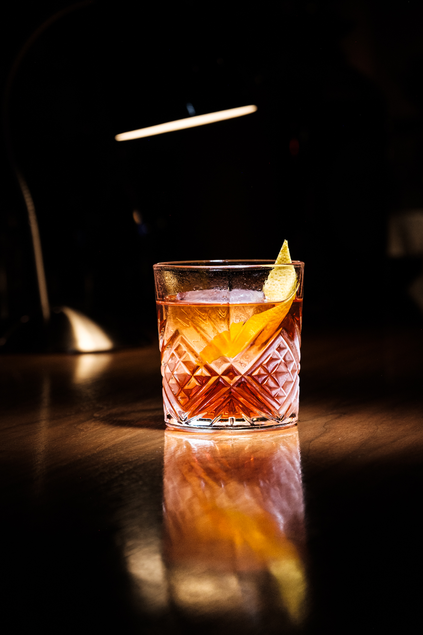 Amber cocktail with citrus peel on the bar at Bar Corso.