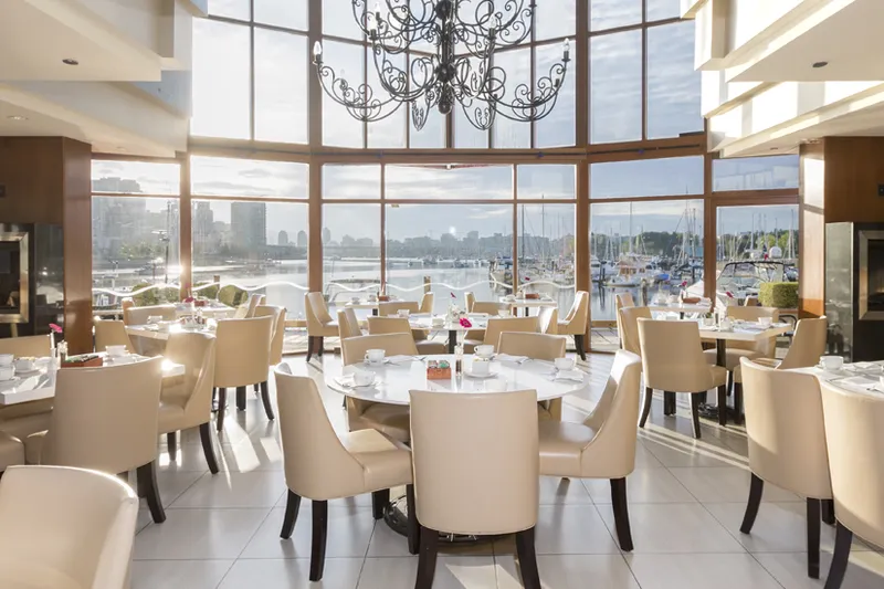 Tables beside the waterfront windows in the dining room at Dockside.