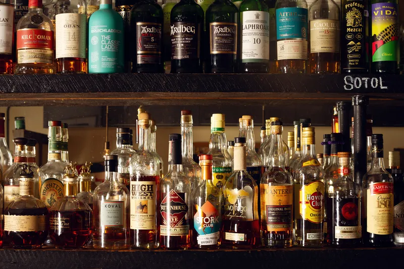 Bottles arranged on the shelves behind the bar at Grapes and Soda.