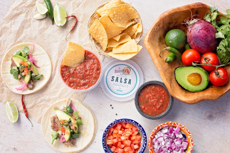Tacos, tortilla chips, salsa and vegetables arranged on a table at Las Margaritas.