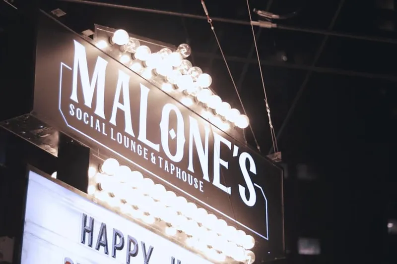 Illuminated Malone’s Taphouse sign on the venue exterior.