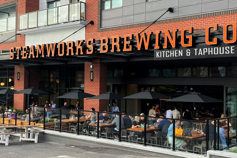 Steamworks storefront and street-side patio beneath the brewery sign.